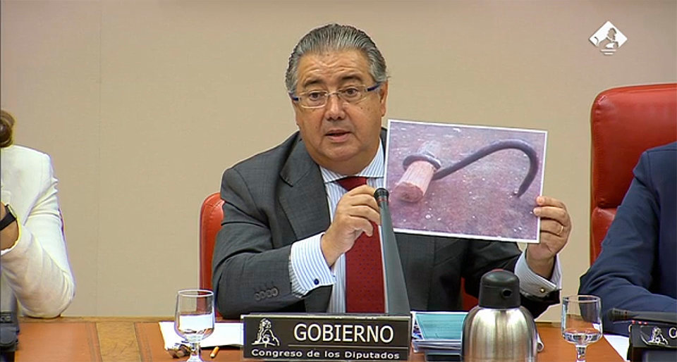 Juan Ignacio Zoido, ministro de Interior, muestra uno de los ganchos presuntamente usados por los migrantes para trepar po rla valla