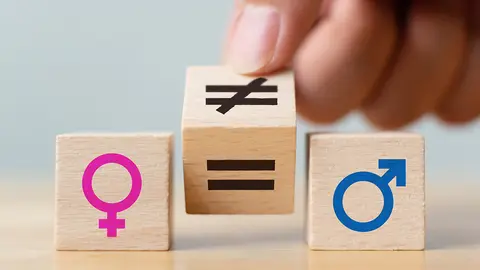 Concepts of gender equality. Hand flip wooden cube with symbol unequal change to equal sign 