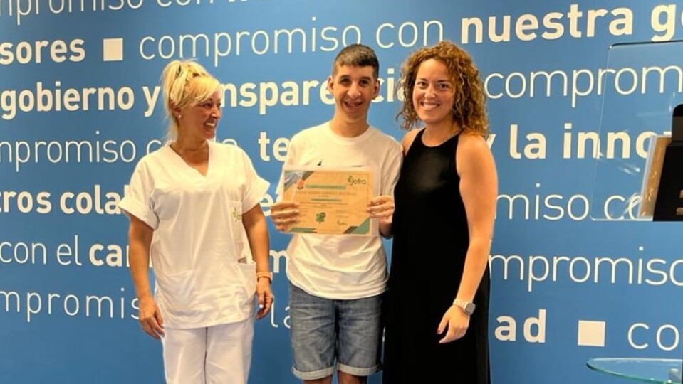 Un usuario de Plena Inclusión, posando junto a un diploma expedido por Endesa