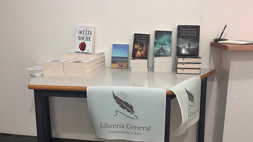 Los libros publicados por May R. Ayamonte en una mesa para su firma y venta durante la Feria del Libro 2025